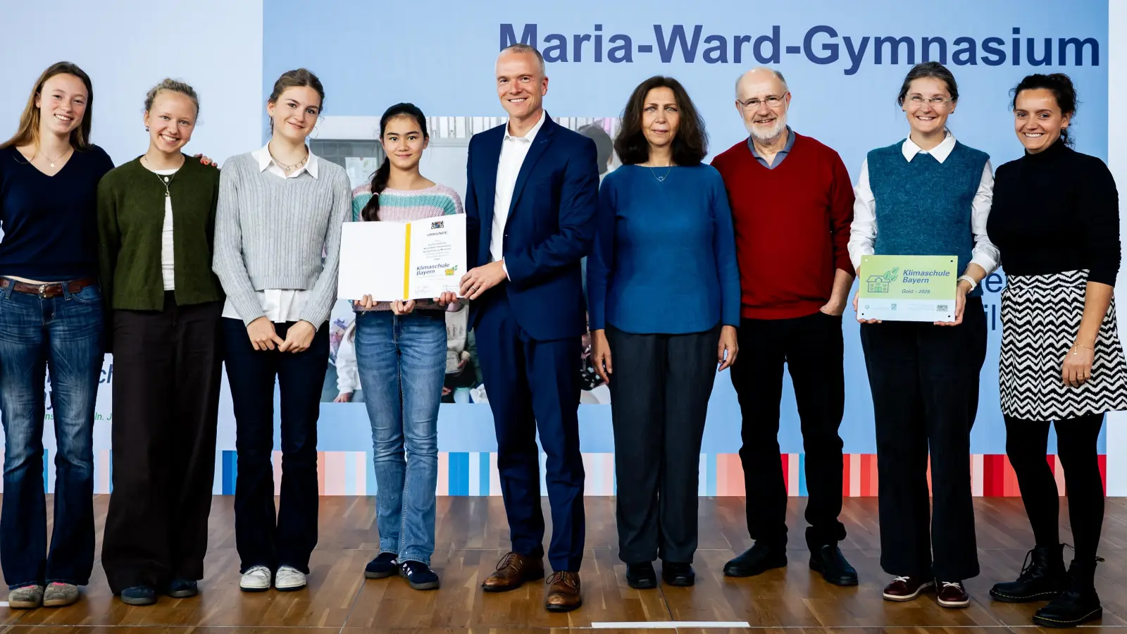Schülerinnen und Lehrkräfte des Maria-Ward-Gymnasiums Nymphenburg zusammen mit Ministerialdirektor Thomas Marzahn (Mitte), Cecilia Scorza-Lesch (Leiterin Klimaschule-Projektkoordination LMU München, 4.v.r.) und Harald Lesch (Schirmherr Klimaschul-Projekt) bei der Urkunden- und Plakettenübergabe. (Foto: Bert Willer)