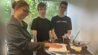 Experiment geglückt - alle Finger sind unverletzt geblieben, Marco (Mitte) und Stefan haben den Roboterarm für einen Nervenkitzel programmiert.  (Foto: pst)