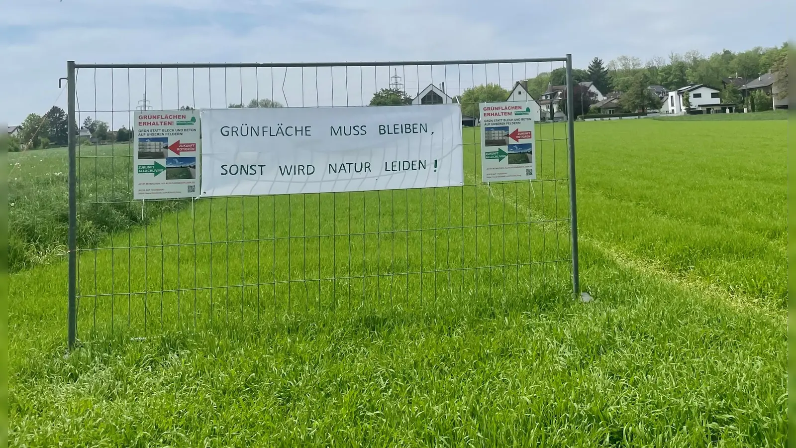 Inzwischen wurden an dem geplanten Standort für die Wohncontainer Plakate zum Erhalt der Grünfläche angebracht. (Foto: bb)
