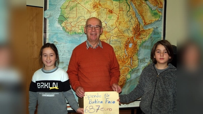Samuel (l.) und Leo von der Montessorischule übergeben stellvertretend für rund 100 Schüler die Spende an Klaus Woithe von der Afrikahilfe „Fanga e.V.“. (Foto: Uta Künkler)