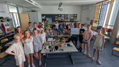 Voller Stolz präsentieren die Schüler der Klasse 4d der Grund- und Mittelschule Unterhaching ihre Spendensammlung für die Ottobrunner Tiertafel.  (Foto: Bayer)