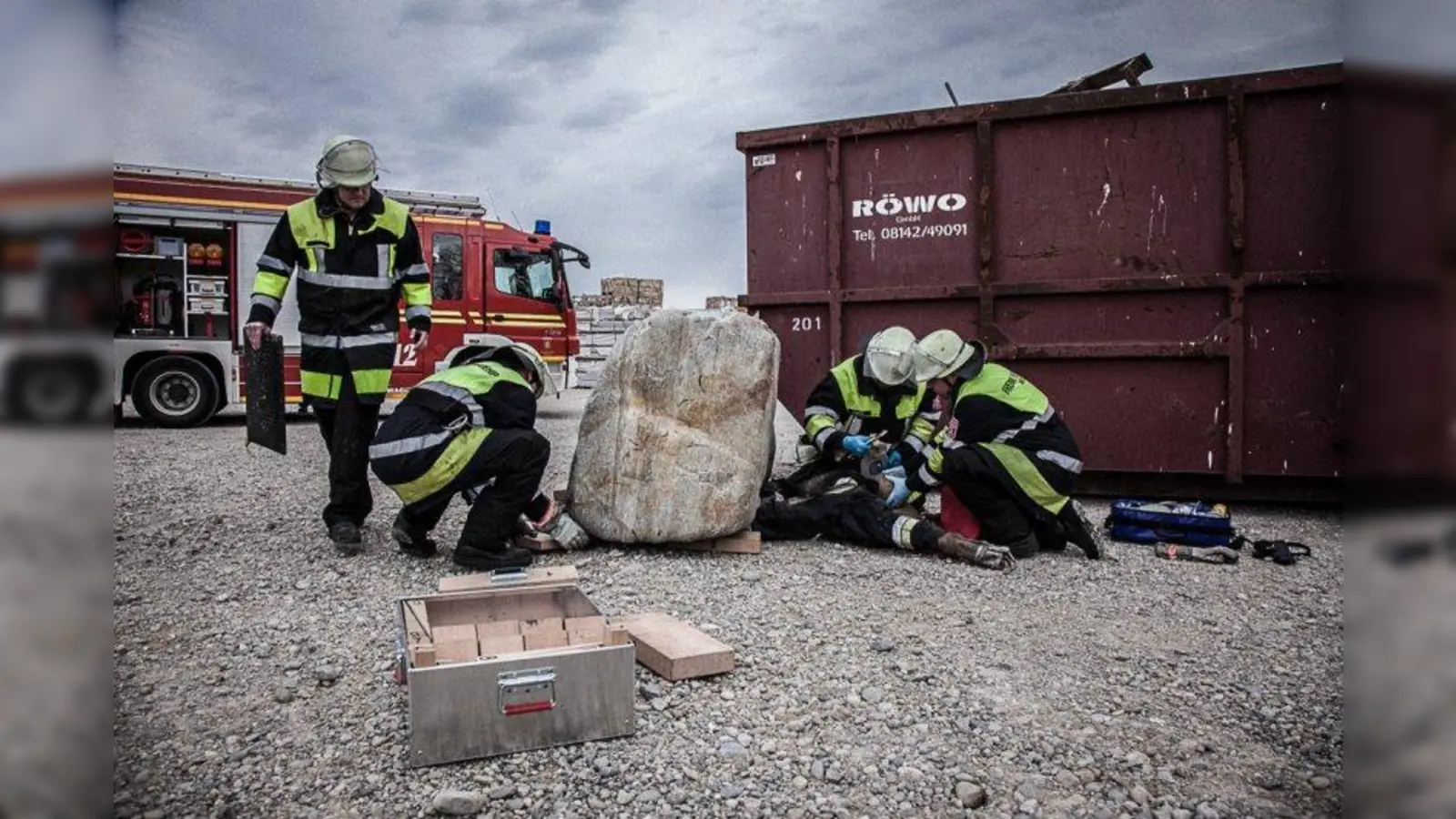 Die Feuerwehrleute üben den Ernstfall. Zum Glück liegt keine echte Person unter dem riesigen Stein. (Foto: FFLL)