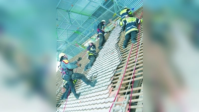 Mitglieder von Feuerwehr und Burschenverein beim Abdecken des Kirchendaches. (Foto: Frieder Vogelsgesang)