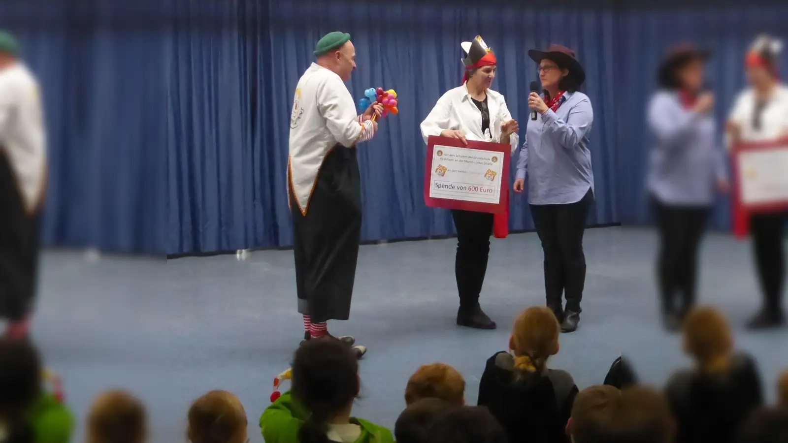 Gemeinsam mit der Elternbeiratsvorsitzenden Rebbeca Wältner überreichte Rektorin Angelika Hartmann dem KlinikClown „Prof. Lupino“ die Spende. (Foto: Jennifer Reisenauer)